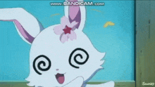 a white rabbit with a pink flower on its ear is making a funny face with swirls in its eyes .