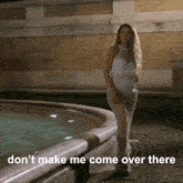 a woman in a white dress stands in front of a fountain with the words " don t make me come over there "