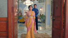 a man and a woman are standing in a hallway