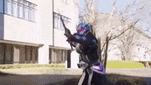 a superhero is holding a sword in front of a building .