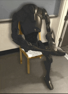 a robot sitting on a chair with a gun