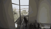 a woman is standing on the stairs of a building with a view of the city .
