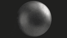 a black and white image of a shiny sphere on a black background .