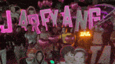 a group of people standing in front of a sign that says " jarfy ang "