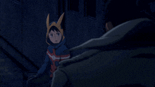 a boy in a hooded jacket is sitting next to a man