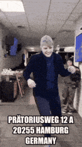 a man dancing in a hallway with the words pratoriousweg 12 a 2025 hamburg germany
