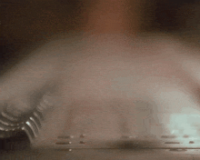 a person is typing on a keyboard with smoke coming out of the keyboard