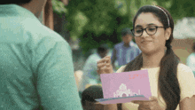 a woman holding a card that says i love you