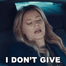 a woman in a car with her eyes closed says i do n't give