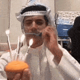 a man is blowing out candles on a cupcake