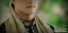 a man wearing a scarf around his neck is being made with vivavideo