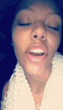 a close up of a woman with her eyes closed and her mouth open
