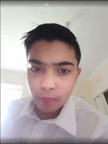 a young man in a white shirt is looking at the camera with the words " you " above his face