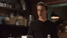 a man making a funny face in a kitchen