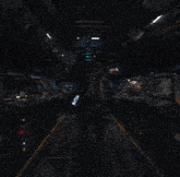 a man in a space suit is walking through a dark room with a glowing object in the middle