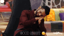 a man in a maroon jacket is sleeping in a chair with the words good night below him