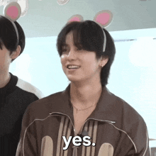 a young man wearing a headband with bunny ears says yes