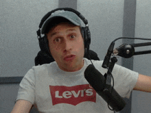 a man wearing headphones and a white levi 's shirt