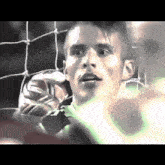 a man holding a soccer ball behind a fence