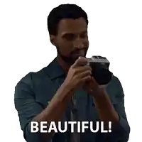 a man holding a camera with the words beautiful written below him