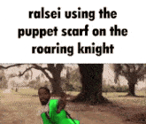 a man wearing a green puppet scarf is standing in front of a tree .