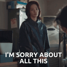 a woman in a black jacket says i 'm sorry about all this in white letters