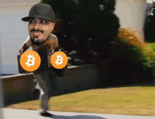 a man wearing a ny yankees hat is carrying a briefcase with two bitcoins on it