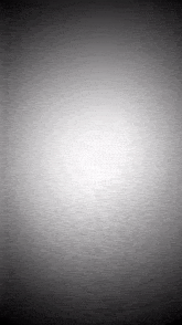 a black and white background with a glowing white circle in the middle .
