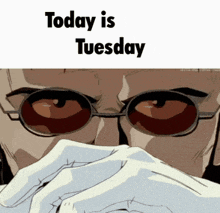 a man wearing glasses covering his mouth with his hands and the words today is tuesday written above him