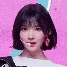 a girl with short hair is wearing a microphone
