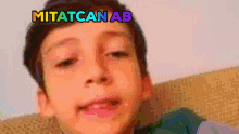 a boy with the word mitatcan ab on his face