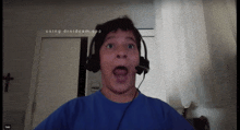 a boy wearing headphones with the words " using droidcam app " on the bottom right