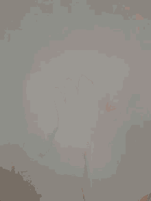 a person 's hand is reaching out towards a white surface
