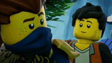 two lego figures are standing next to each other and one has a blue scarf around his face