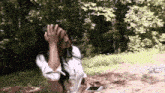 a woman is covering her face with her hand while holding a cell phone