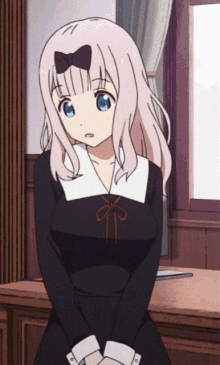 a girl with pink hair and blue eyes is wearing a black and white dress