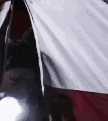 a close up of a person standing in a tent with a light shining through the tent .