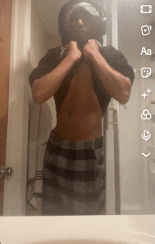 a man is taking a picture of himself in a bathroom mirror with a bunch of icons on it