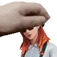 a woman with red hair and sunglasses is being held by a hand .