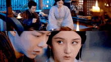 a man and a woman are sitting next to each other in a room .
