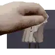 a close up of a person 's hand holding a piece of paper in front of a picture of a person .