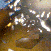 a blurred image of a person 's face with a few spots of light on it