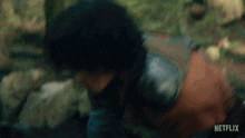 a blurred image of a person with a netflix logo on the bottom