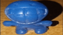 a small blue toy with a helmet on it
