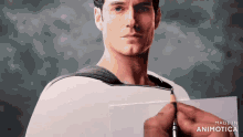 a person is drawing a picture of superman on a piece of paper