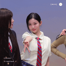 a girl wearing a tie and a white shirt has the word todongyi on the bottom