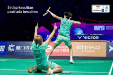 two badminton players on a court with the words setiap kesulitan pasti ada kesulitan on the bottom