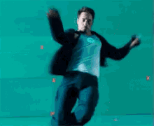 a man in a blue jacket is laying on a blue surface
