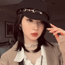 a woman wearing a hat and a choker is standing in a room .