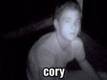 a black and white photo of a young man with the name cory on the bottom right